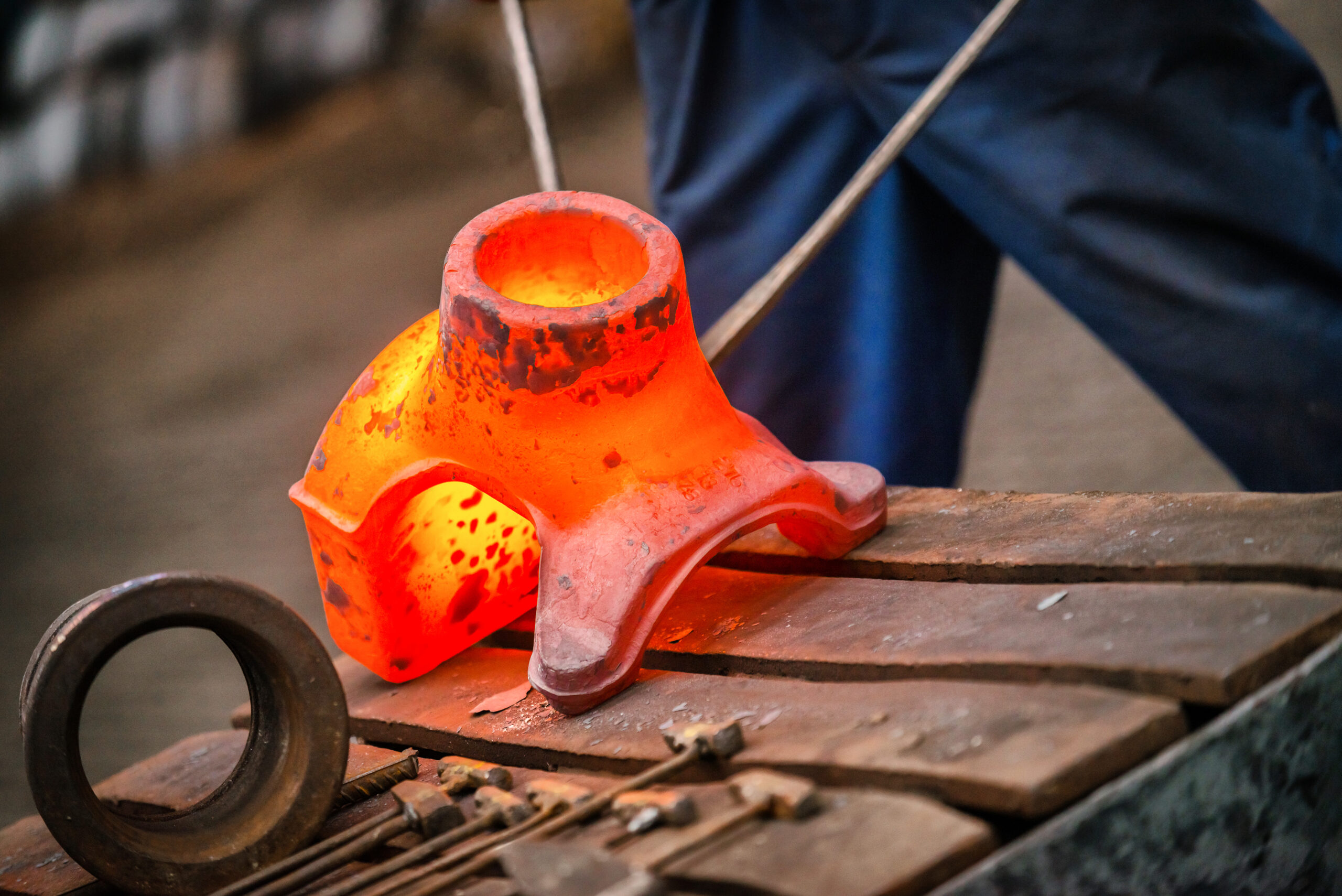 Hot,Iron,In,Smeltery,Held,By,A,Worker